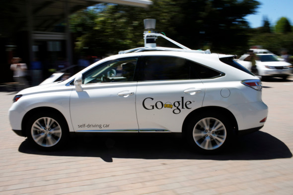 A Google self-driving vehicle drives around the parking lot at the Computer History Museum after a presentation in Mountain View, California