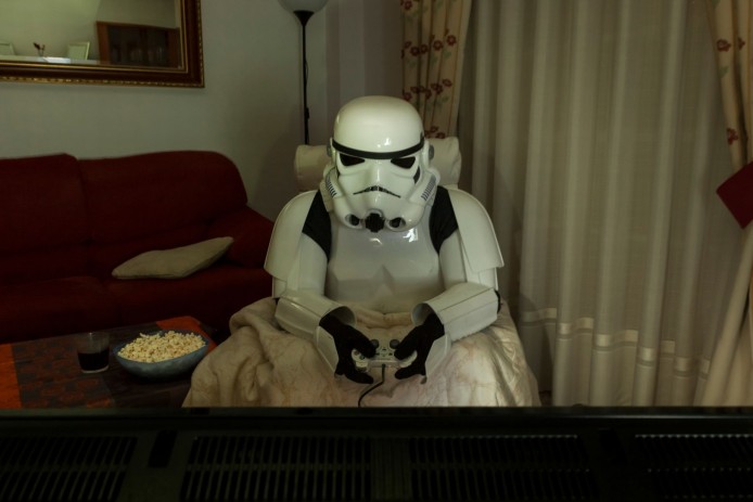 PAY-A-Stormtrooper-sitting-in-the-dark-playing-video-games-with-snacks